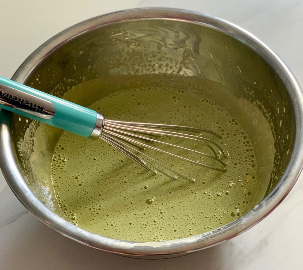 Mixing mint and egg yolks for ice cream
