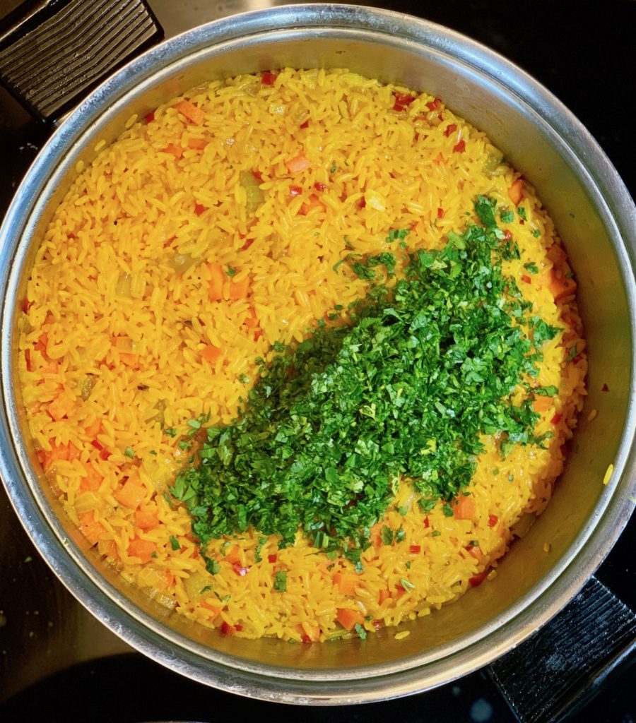 Add fresh herbs last to an arroz con pollo dish