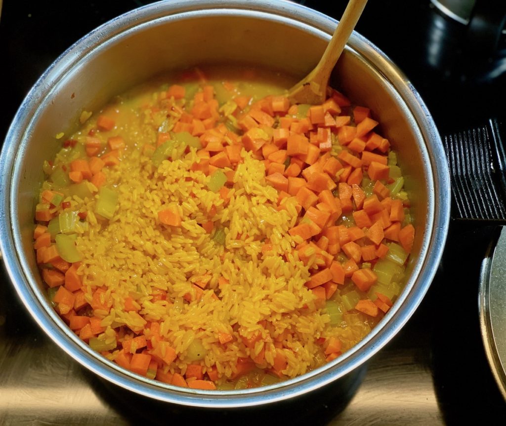 Add in carrots to arroz con pollo after rice is cooked